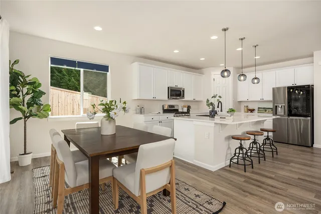 a kitchen with white cabinets and refrigerator