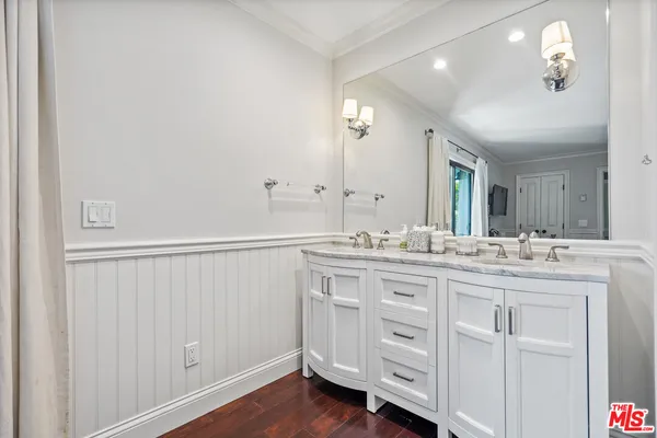 a bathroom with a double vanity sink and a mirror