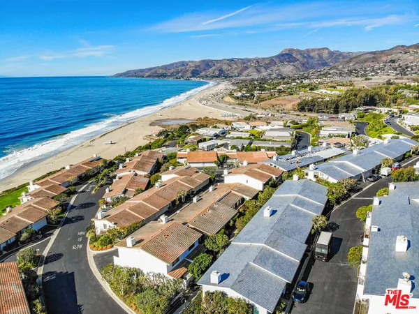 an aerial view of residential building and ocean view
