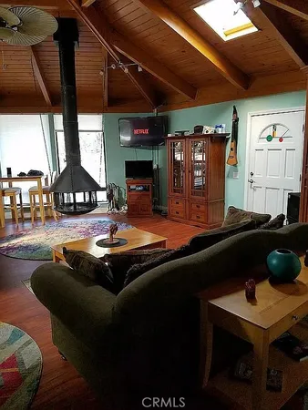 a living room with a table chairs and a fireplace