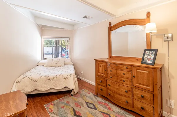 a bedroom with a bed and a dresser