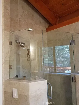 a bathroom with a granite countertop sink a toilet and shower