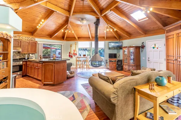 a living room with furniture a couch and large windows