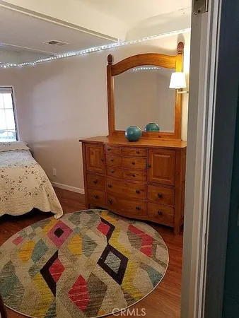 a bed sitting in a bedroom next to a window