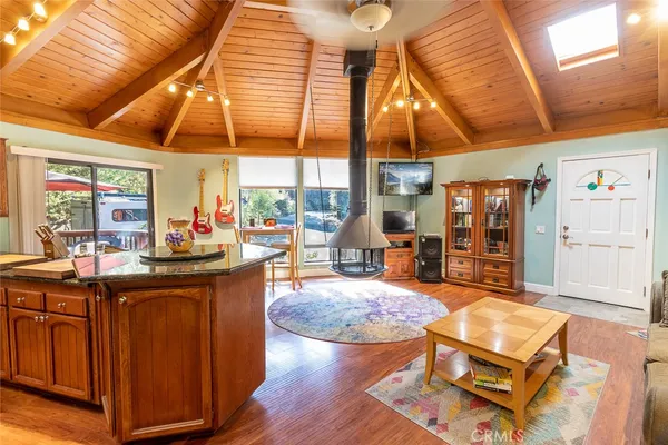 a living room with furniture a flat screen tv and a table