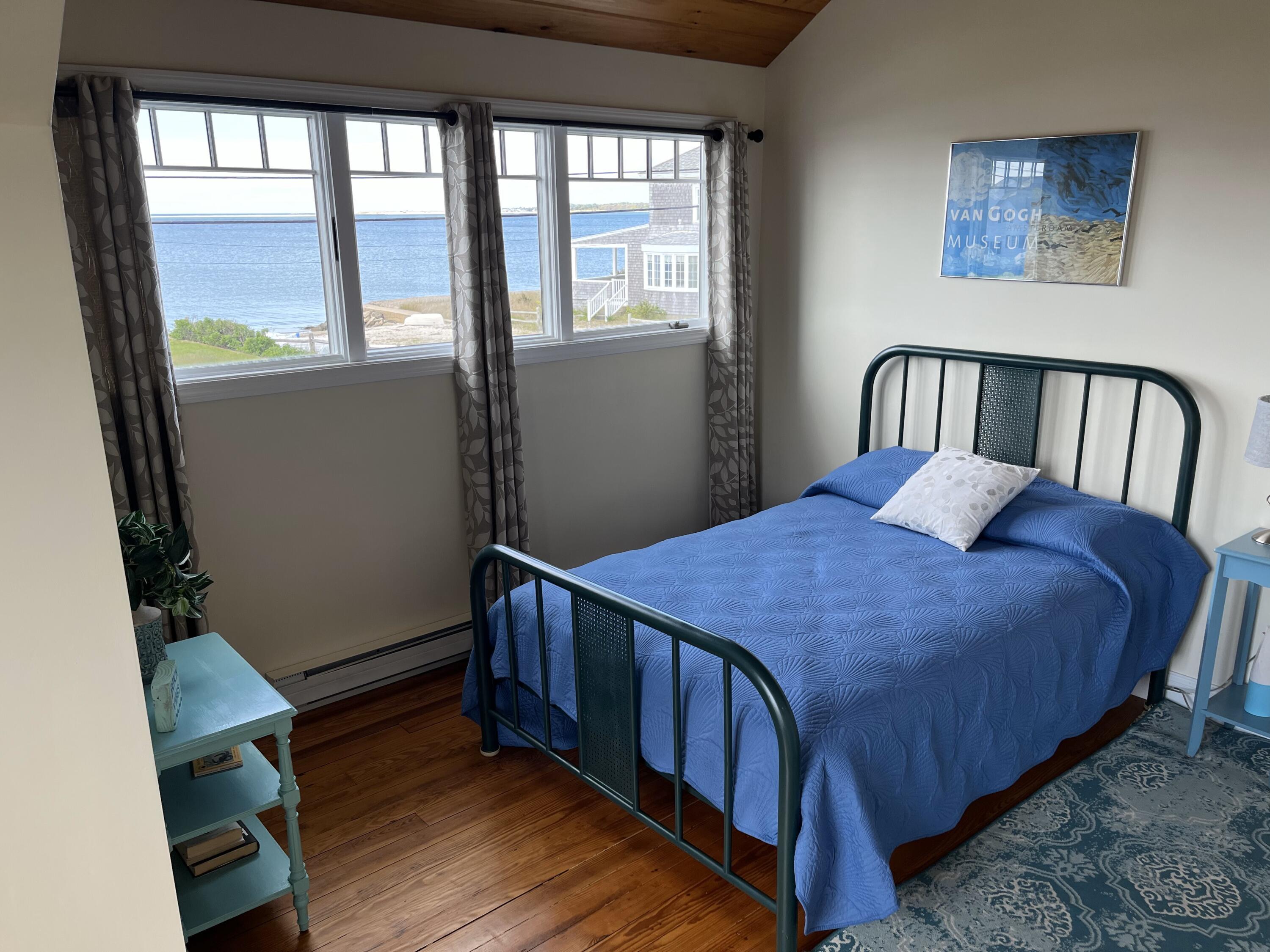 32 Shore Road West Yarmouth, MA 02673 - Photo 14 of 23 a bedroom with a bed next to a window