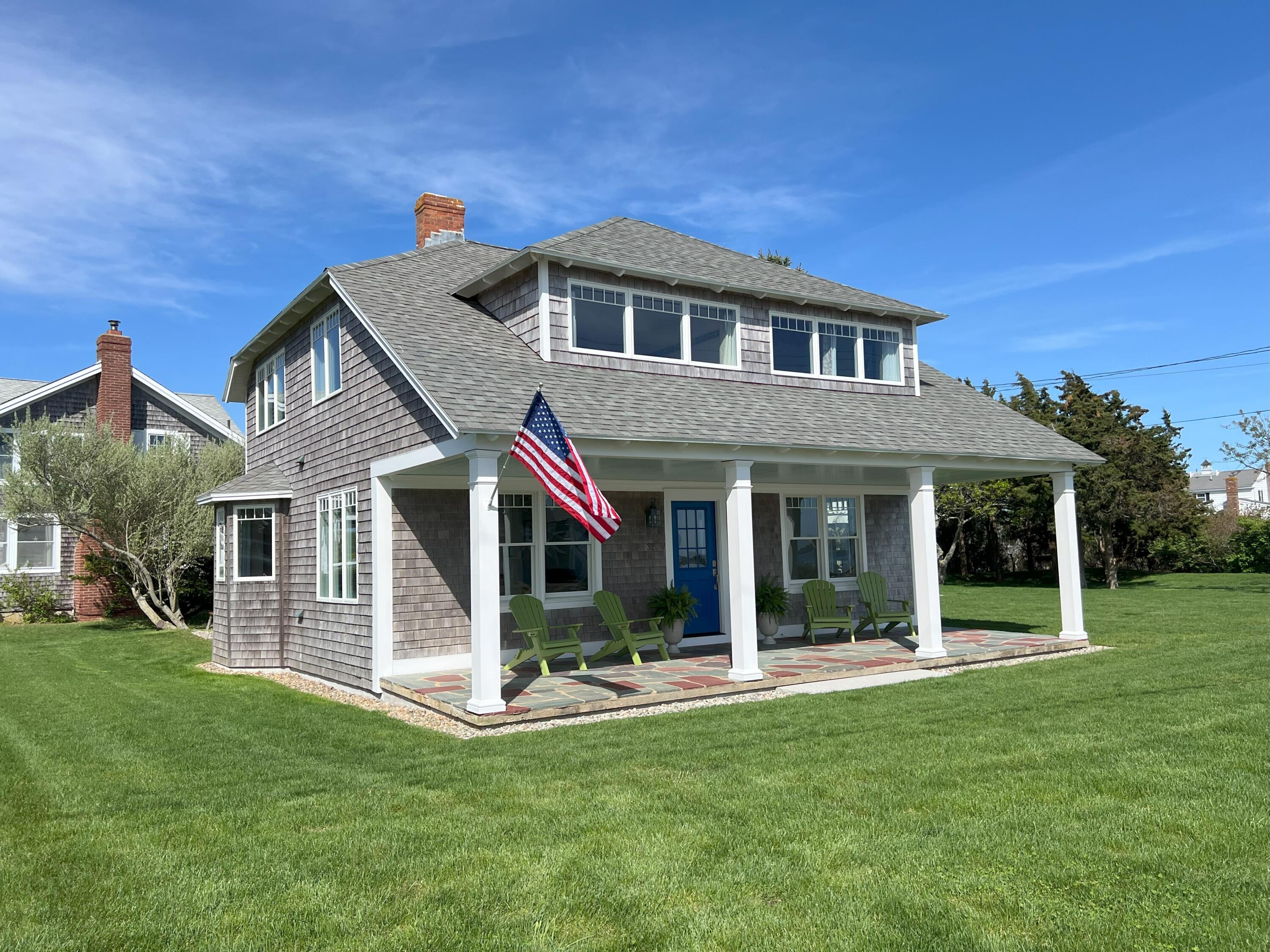 32 Shore Road West Yarmouth, MA 02673 - Photo 3 of 23 a view of a house with a yard and sitting area