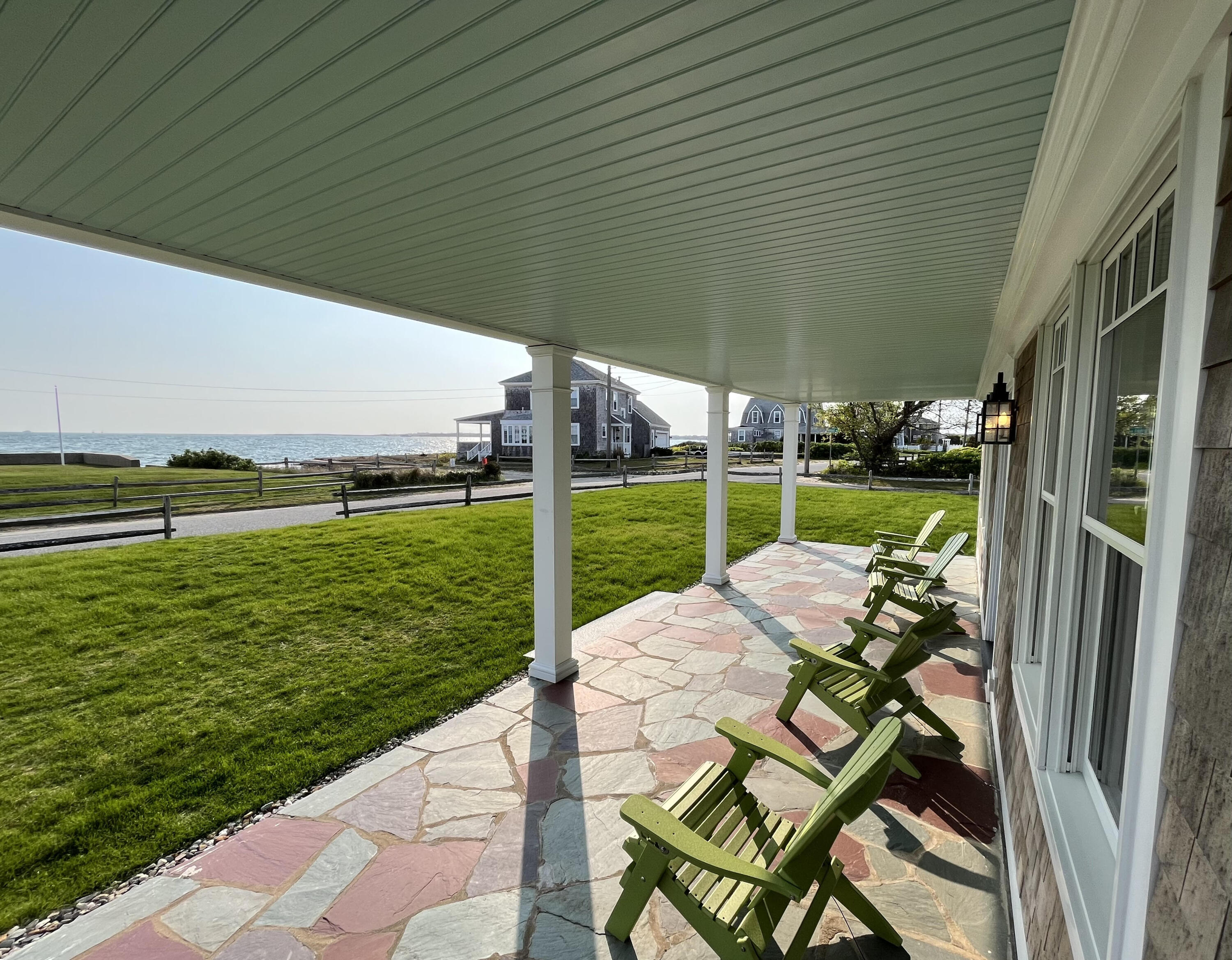 32 Shore Road West Yarmouth, MA 02673 - Photo 4 of 23 a view of a patio with table and chairs under an umbrella