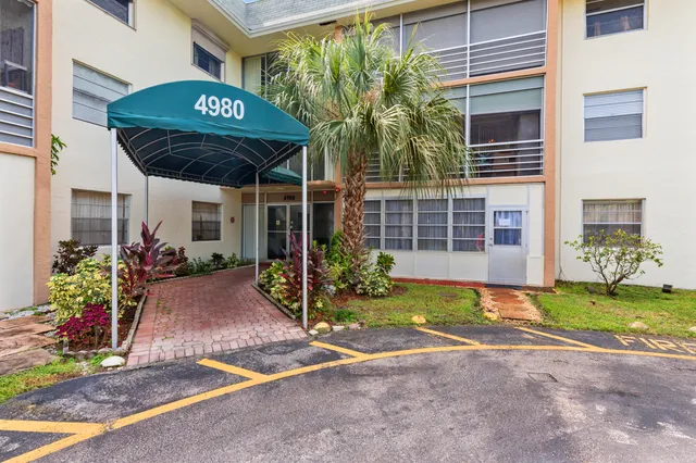 a view of a backyard with a table and chairs under an umbrella