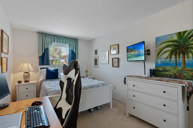 a bedroom with furniture and a flat screen tv