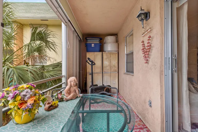 a room with painting on the wall and a large window