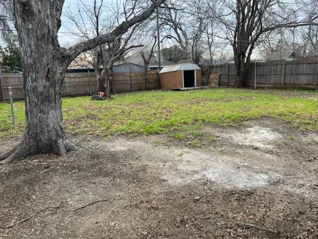 a view of a house with large trees and a yard