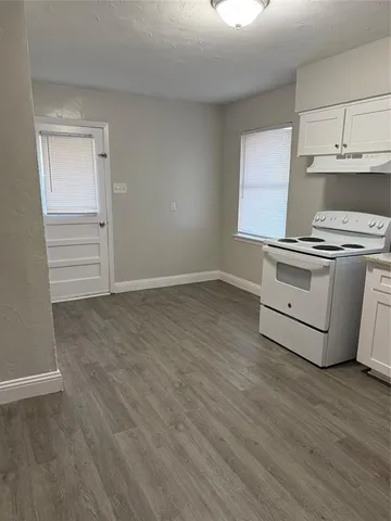 a kitchen with granite countertop a stove and a sink