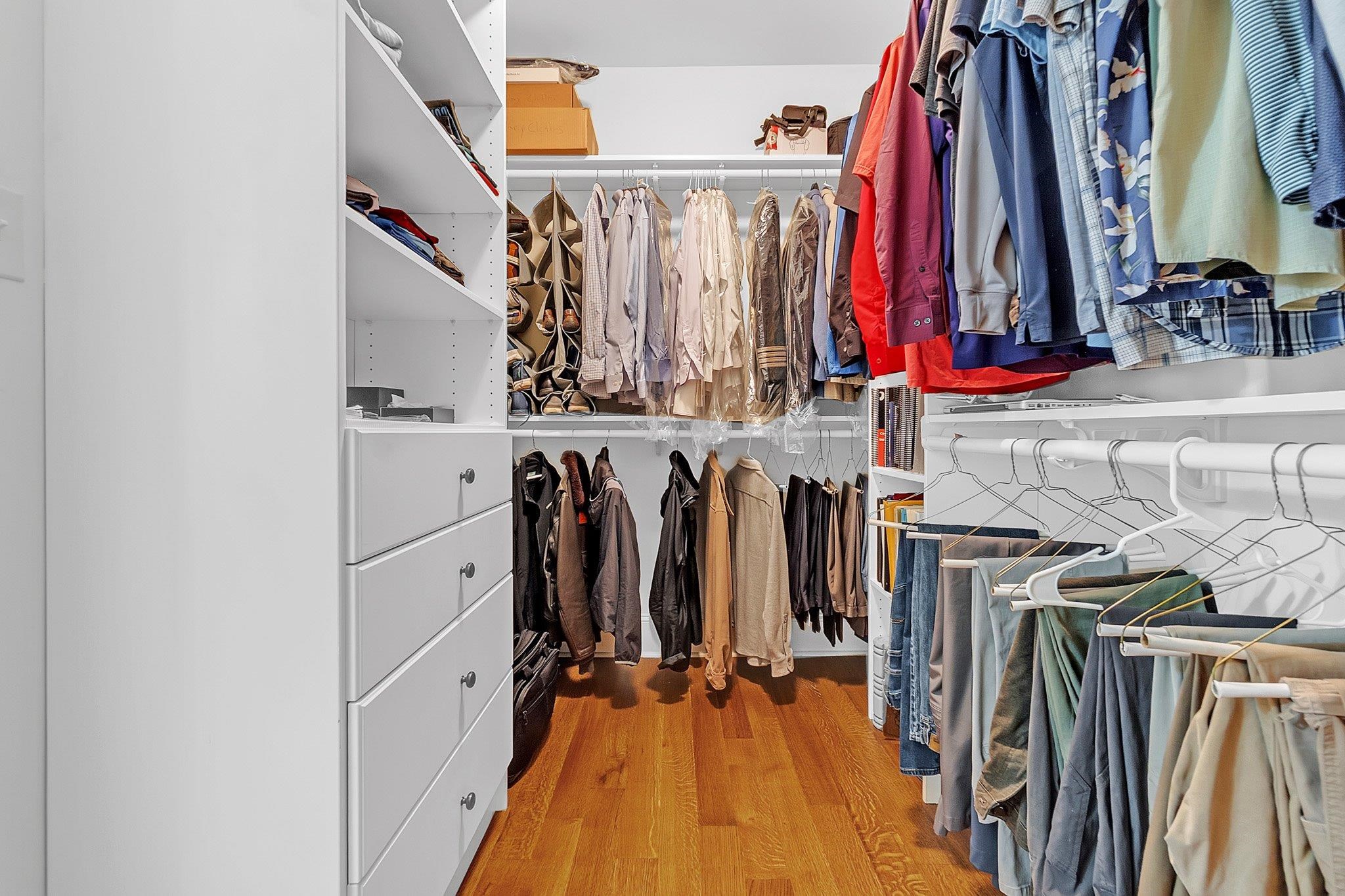 3246 North Hartwell Ridge Drive Collierville, TN 38017 - Photo 24 of 40 Walk-in closet featuring custom built-in shelving, multiple hanging rods, four integrated drawers, and wood-finish flooring