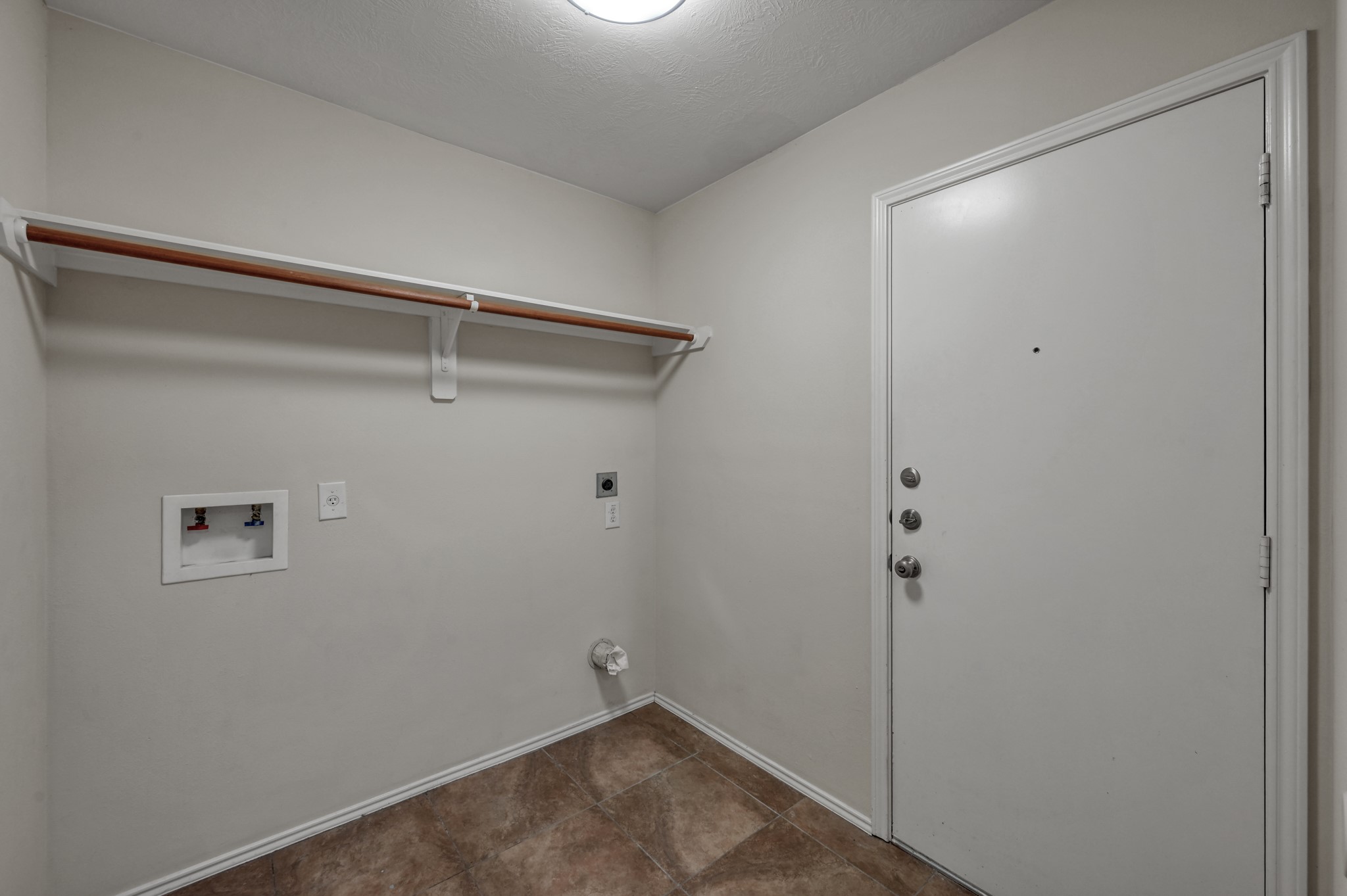 23919 Kingbriar Drive Spring, TX 77373 - Photo 19 of 33 A dedicated utility room offers laundry hookups, additional storage space, and convenient access to the garage.