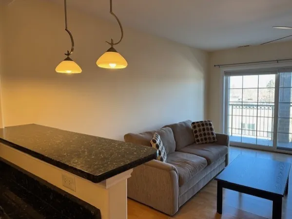 a view of an empty room with a kitchen