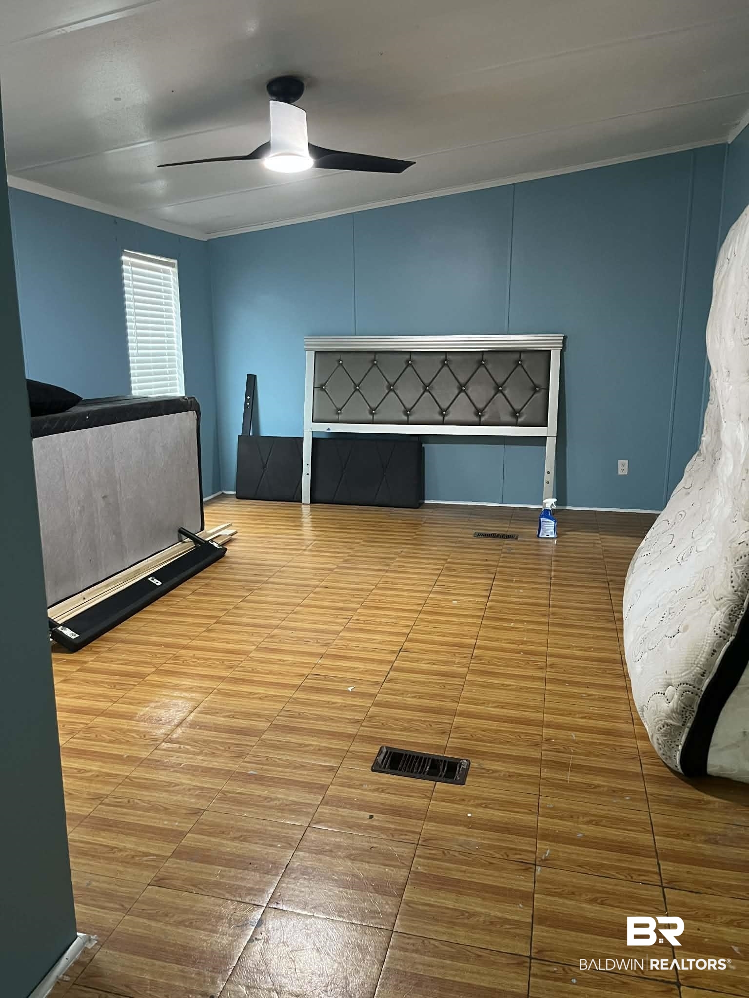 9628 Bryant's Lndg Road Stockton, AL 36579 - Photo 3 of 7 Unfurnished bedroom featuring ceiling fan, ornamental molding, and a decorative wall