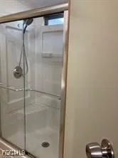 a bathroom with a glass shower door