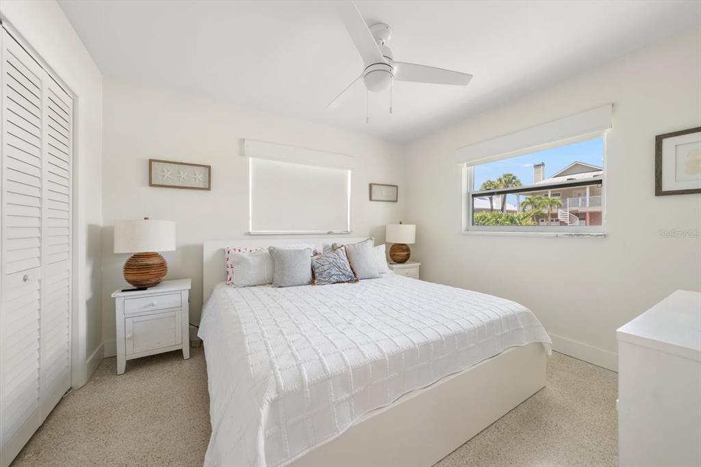 127 11th Avenue Indian Rocks Beach, FL 33785 - Photo 15 of 63 a bedroom with a bed and a large mirror