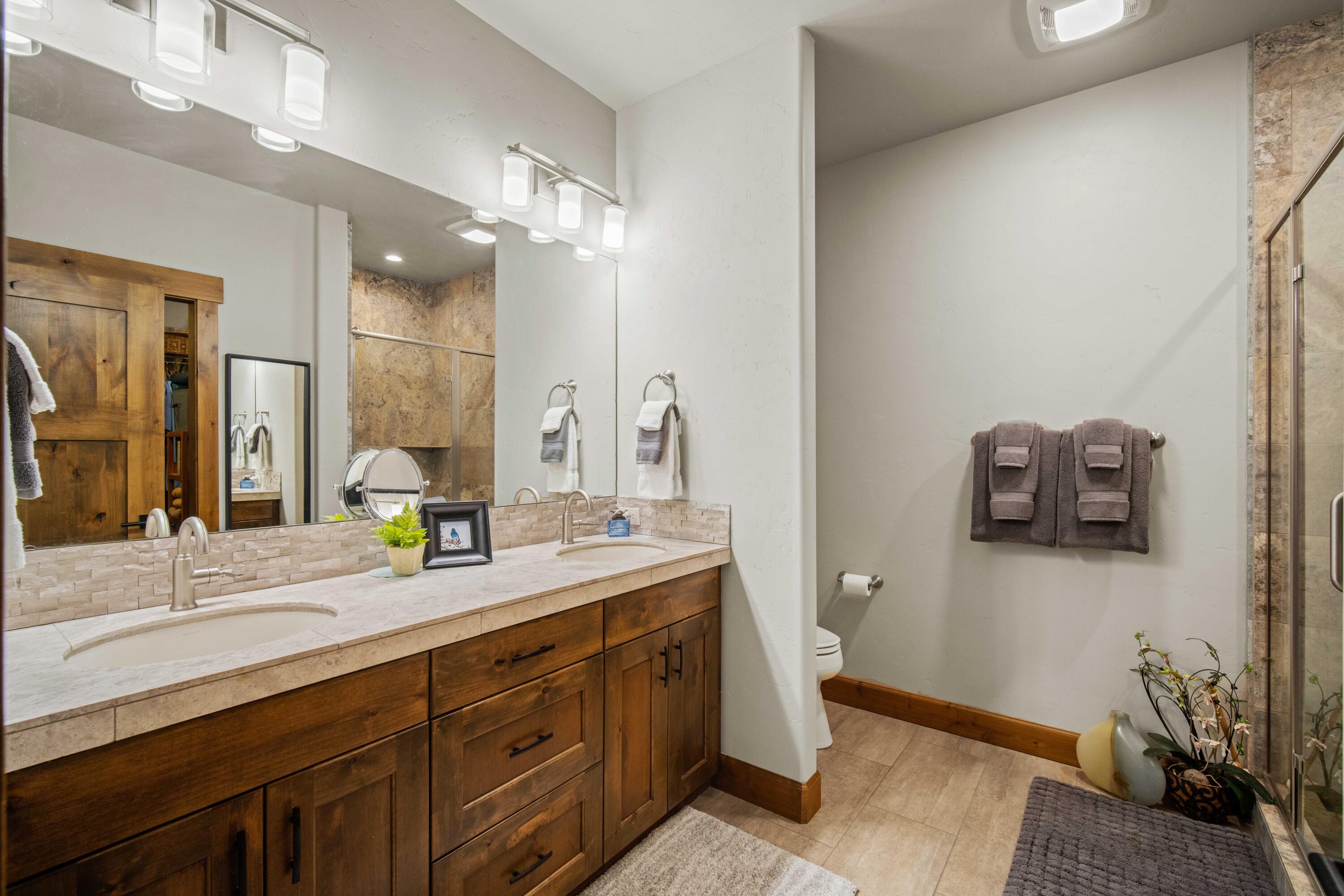16927 Covina Road Bend, OR 97707 - Photo 19 of 54 Primary bathroom in DRRH home with dual vanity, warm wood cabinetry, and a spacious layout designed for everyday comfort.