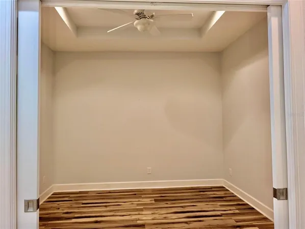 a view of a room with wooden floor and closet