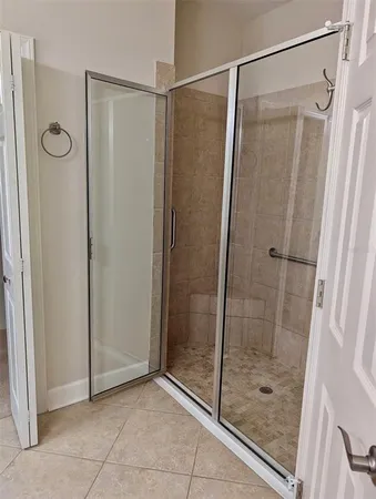 a bathroom with a glass shower door