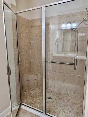 a bathroom with a glass shower door