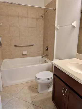 a white toilet sitting next to a bath tub and shower