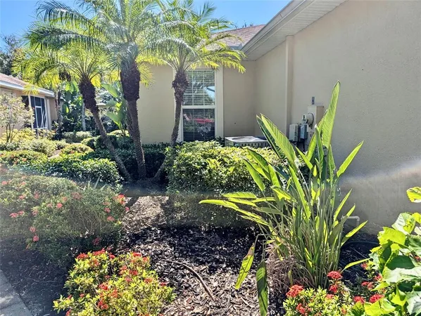 a front view of a house with a yard and flowers