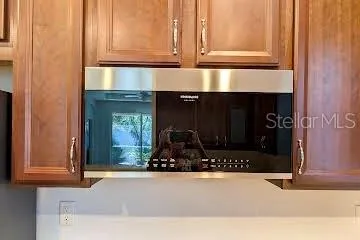 a kitchen with a sink and wooden cabinets