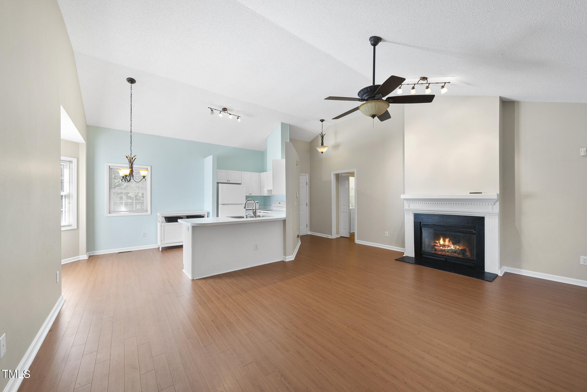 3519 Streams Of Fields Drive Raleigh, NC 27604 - Photo 6 of 20 a view of a kitchen with refrigerator and a fireplace