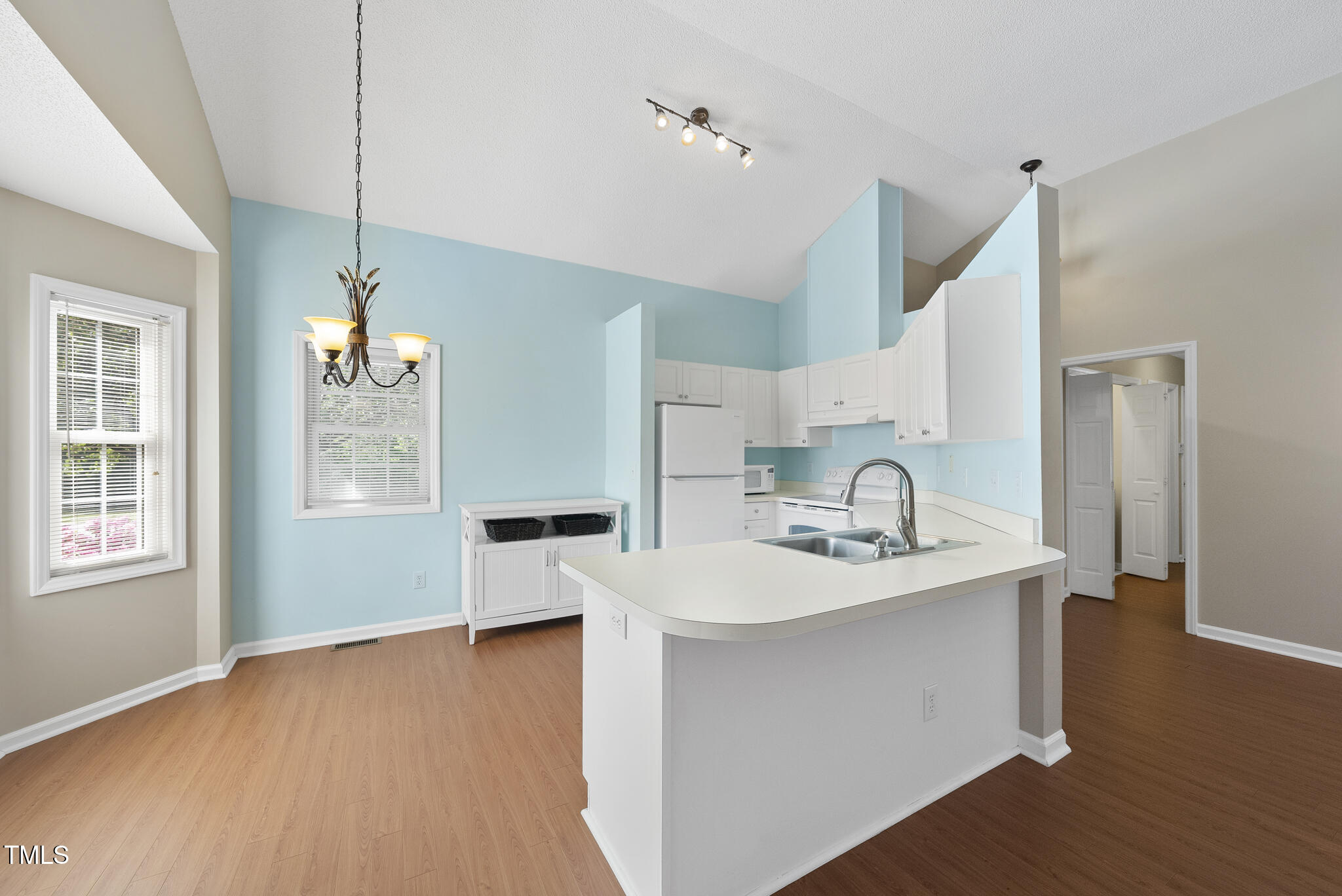 3519 Streams Of Fields Drive Raleigh, NC 27604 - Photo 7 of 20 a view of a kitchen counter space a sink wooden floor and a window