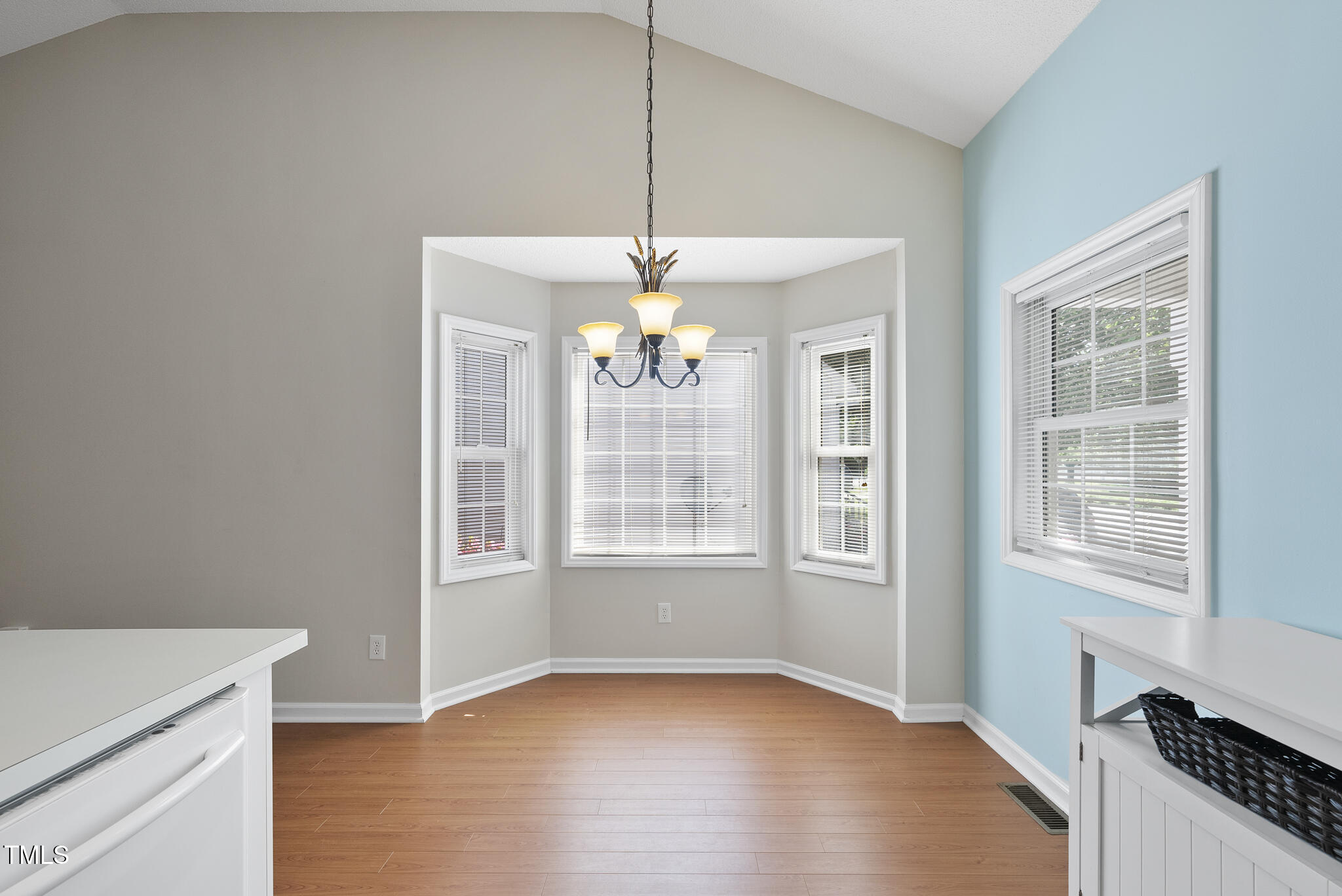 3519 Streams Of Fields Drive Raleigh, NC 27604 - Photo 8 of 20 an empty room with wooden floor cabinet and windows