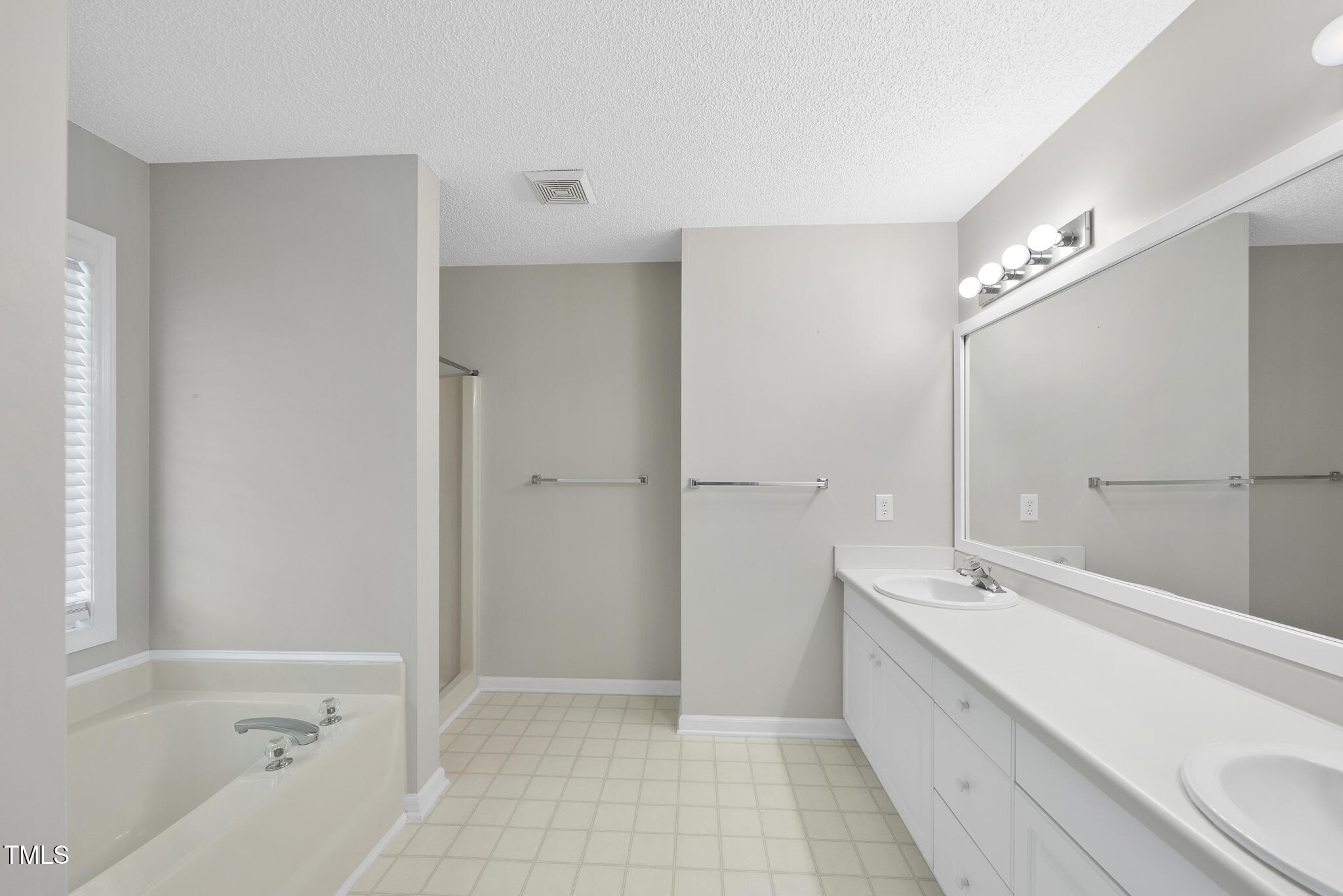 3519 Streams Of Fields Drive Raleigh, NC 27604 - Photo 10 of 20 a bathroom with a bathtub and a sink