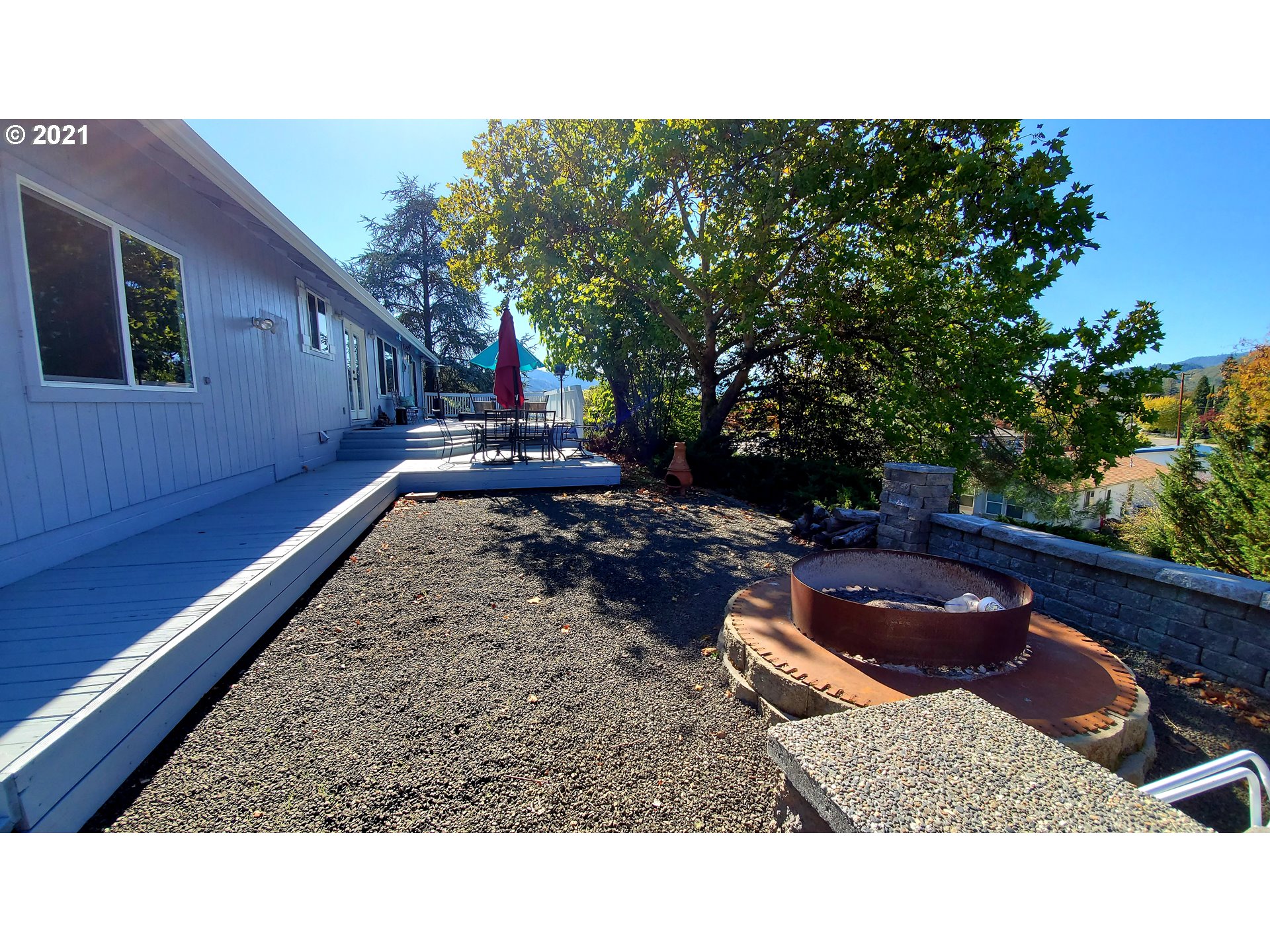 160 Oak Street Riddle, OR 97469 - Photo 3 of 32 a backyard of a house with table and chairs