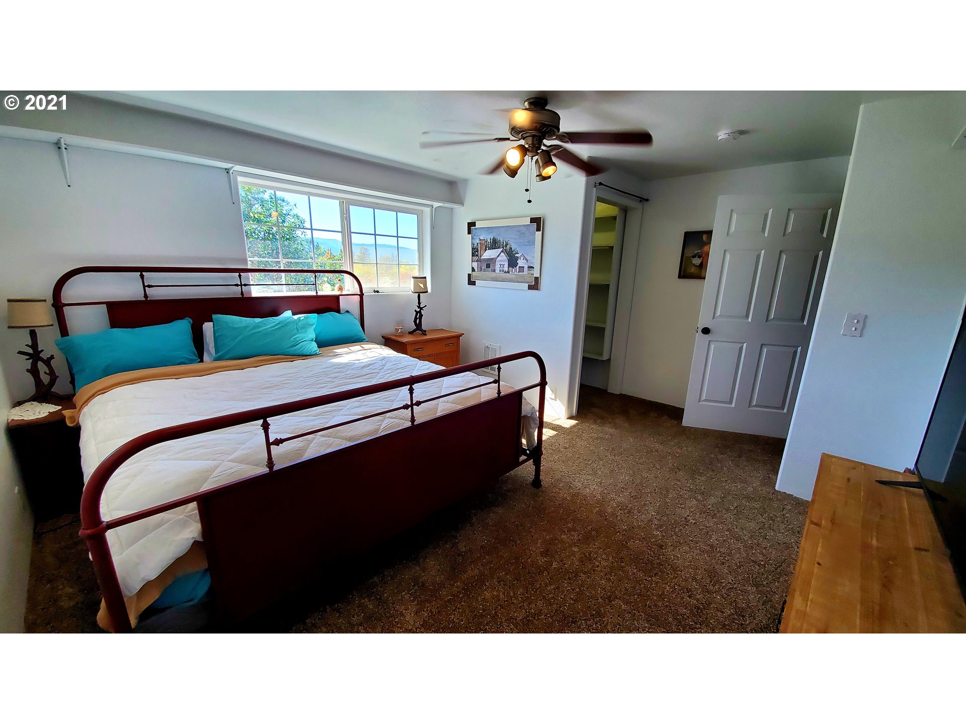 160 Oak Street Riddle, OR 97469 - Photo 22 of 32 a living room with a bed furniture and a window