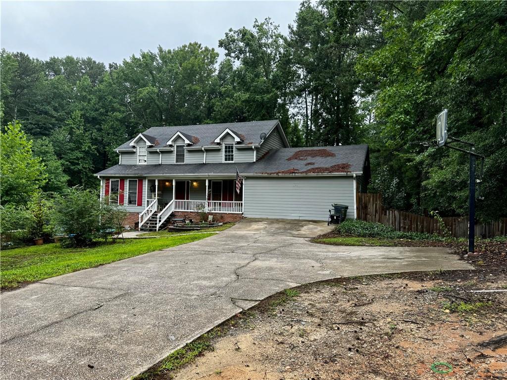 a front view of a house with a yard and trees