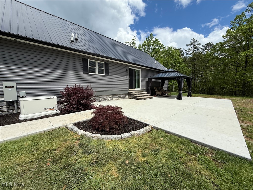 399 Wilder Road Vinton, OH 45686 - Photo 3 of 36 Rear view of house with a metal roof, a gazebo, a patio area, entry steps, and a lawn