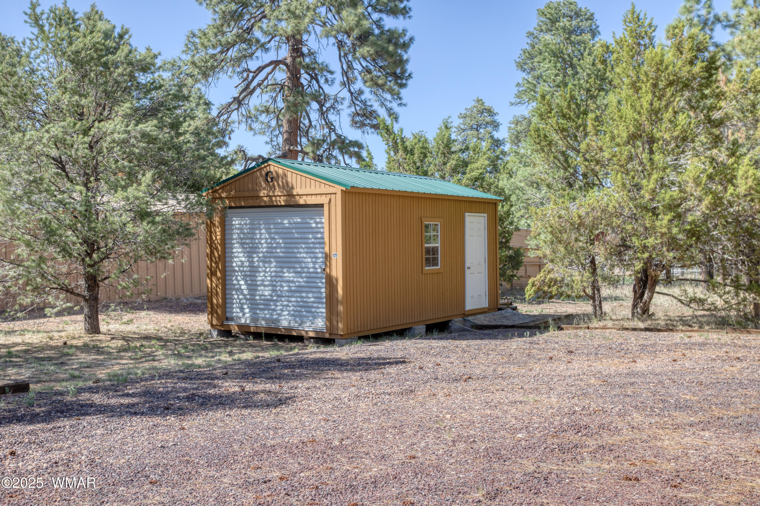 2905 Pine Rim Road Overgaard, AZ 85933 - Photo 6 of 19 a view of a house with a yard and garage