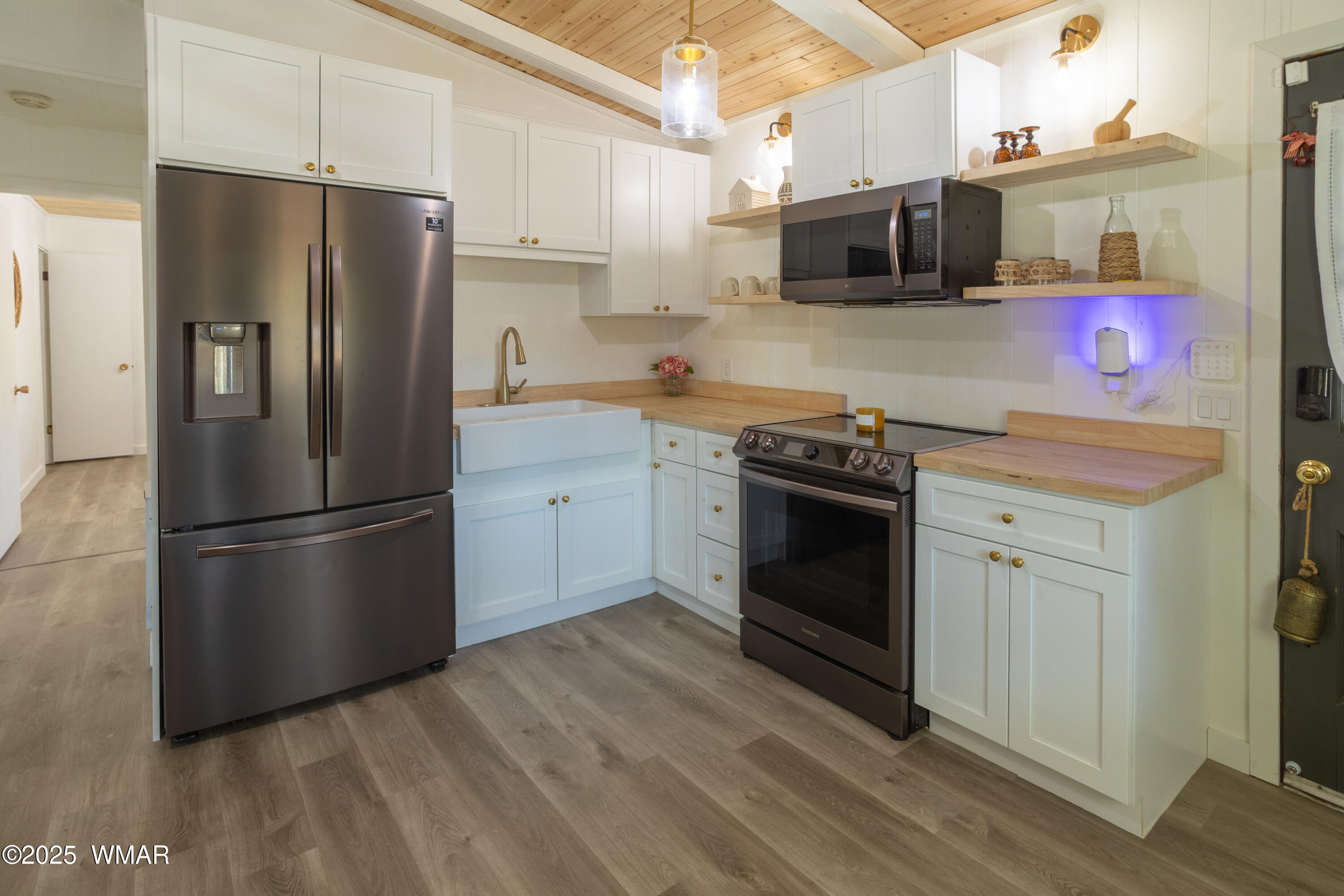 2905 Pine Rim Road Overgaard, AZ 85933 - Photo 9 of 19 a kitchen with stainless steel appliances a refrigerator sink and microwave