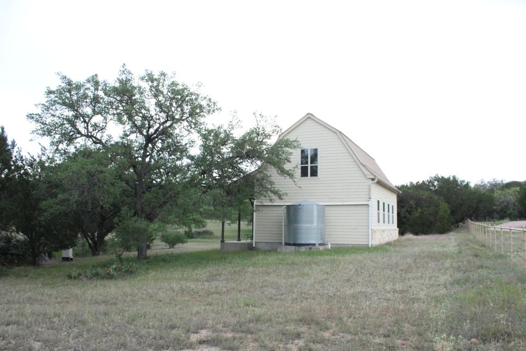 5135 Lookout Ridge Drive Marble Falls, TX 78654 - Photo 26 of 33 Backyard with water collection cistern