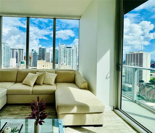 a living room with furniture and a floor to ceiling window