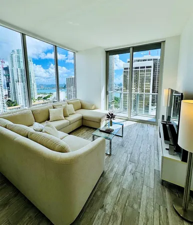 a living room with furniture and a large window