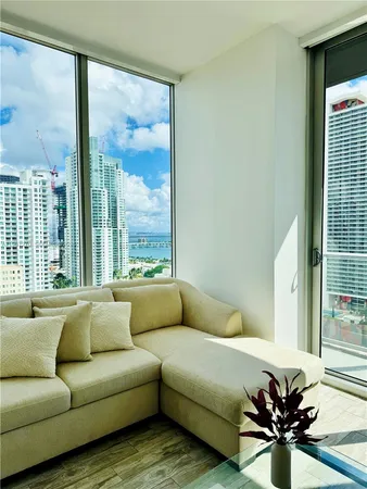 a living room with furniture and a large window