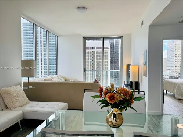 a view of living room filled with furniture and a potted plant