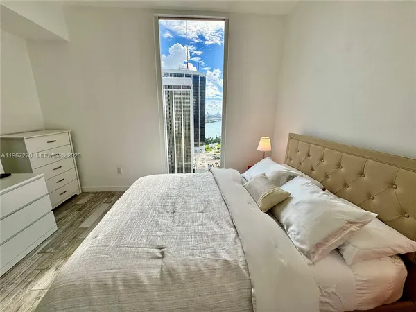 a bedroom with a bed and a window