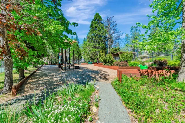 a view of a patio with a table chairs and a backyard