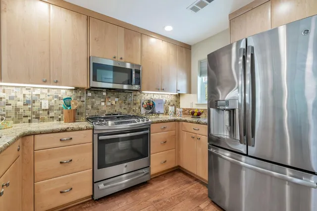 a spacious bedroom with a bed and a large window