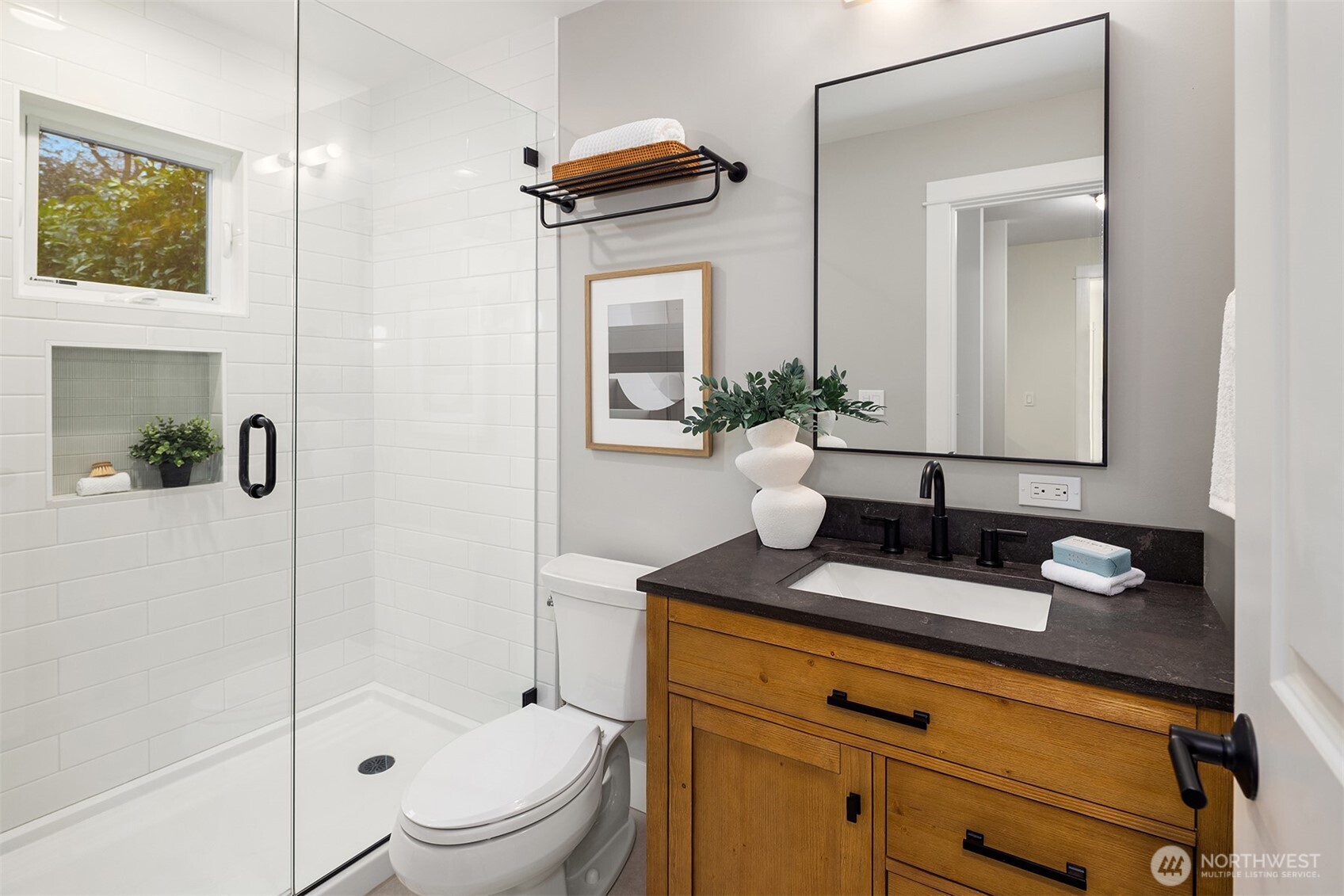 721 North 97th Street Seattle, WA 98103 - Photo 15 of 35 a bathroom with a granite countertop sink mirror vanity and toilet