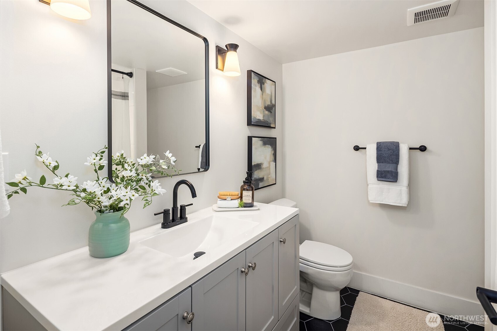 721 North 97th Street Seattle, WA 98103 - Photo 25 of 35 a bathroom with a sink a toilet and mirror
